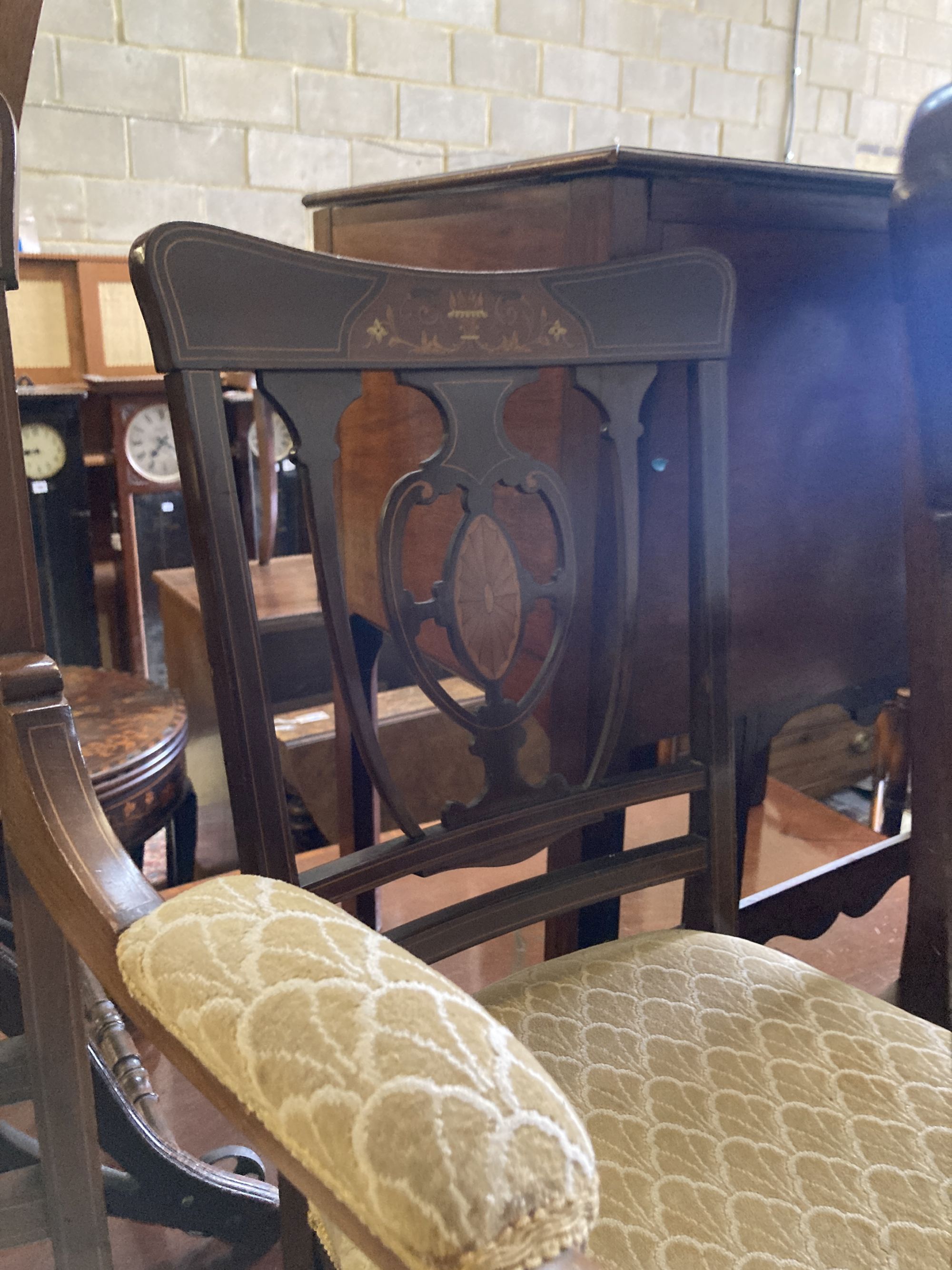 A pair of Edwardian inlaid mahogany elbow chairs and a matching single chair (3)